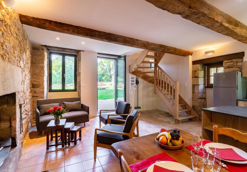 eine Küche und ein Wohnzimmer mit einer Steinmauer in der Unterkunft Gîte de l'Abbaye in Brandivy