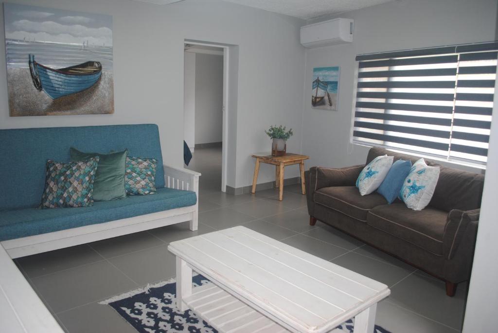 a living room with a couch and a coffee table at Barefoot Bungalo in Amanzimtoti