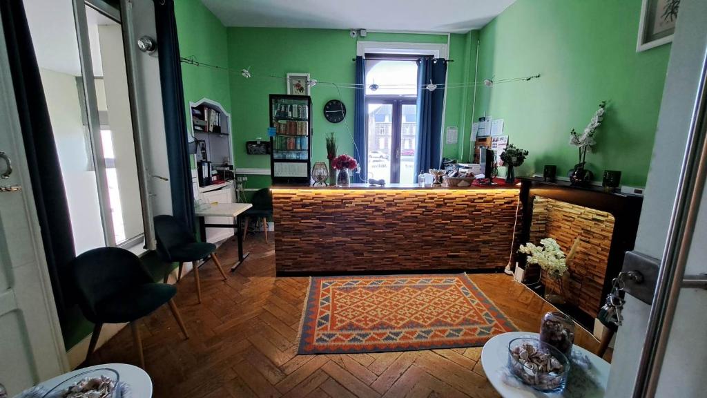 a living room with green walls and a wooden floor at hotel Melissa in Péruwelz