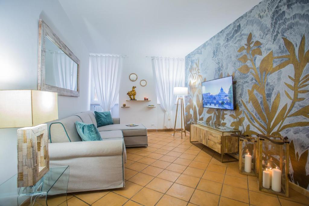 ein Wohnzimmer mit einem Sofa und einem TV in der Unterkunft Domus Regola Luxury Apartment in Rom