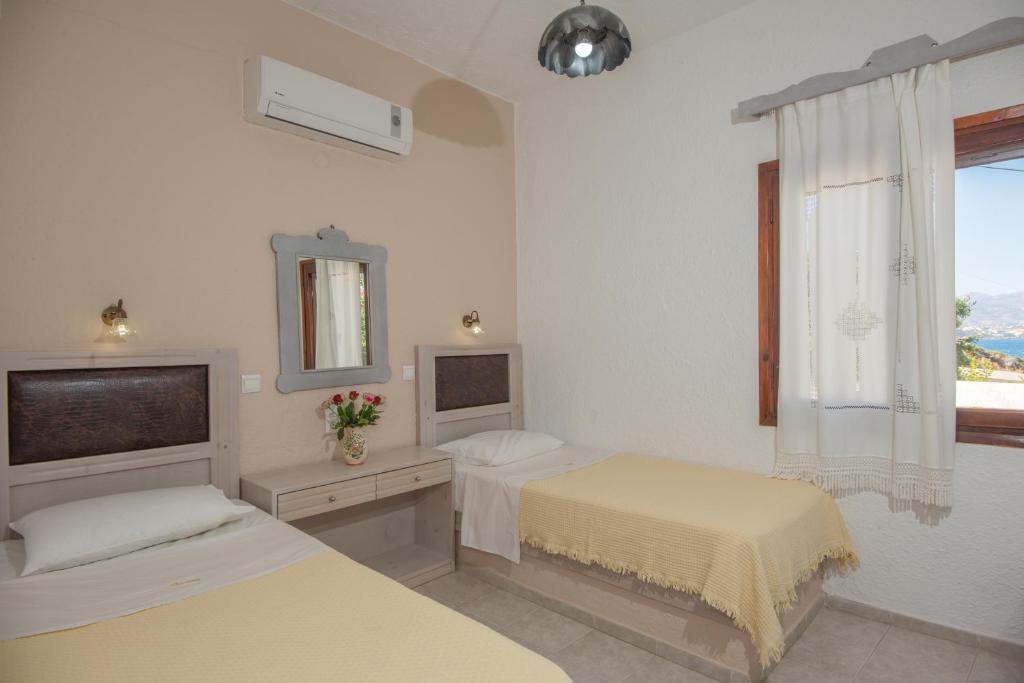 Postel nebo postele na pokoji v ubytování Vangelis Villas