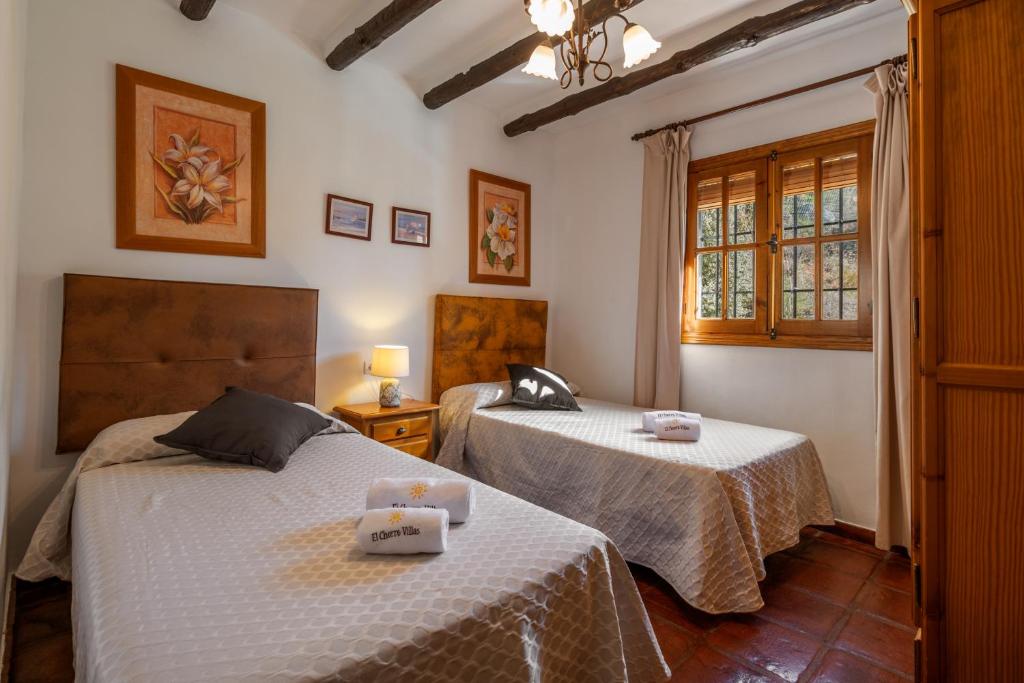 Postel nebo postele na pokoji v ubytování El Chorro Villas Casa Buganvilla