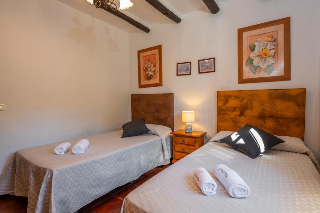 Postel nebo postele na pokoji v ubytování El Chorro Villas Casa Buganvilla