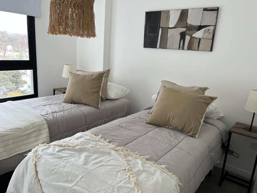 zwei nebeneinander stehende Betten in einem Schlafzimmer in der Unterkunft Temponorte Salta II in Salta