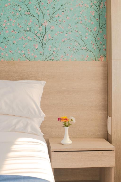 Postel nebo postele na pokoji v ubytování Mila Hotel