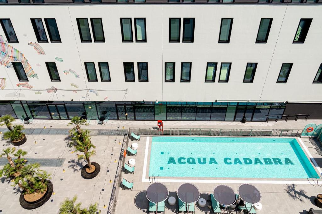 an overhead view of a building with a swimming pool at The Social Hub Bologna in Bologna