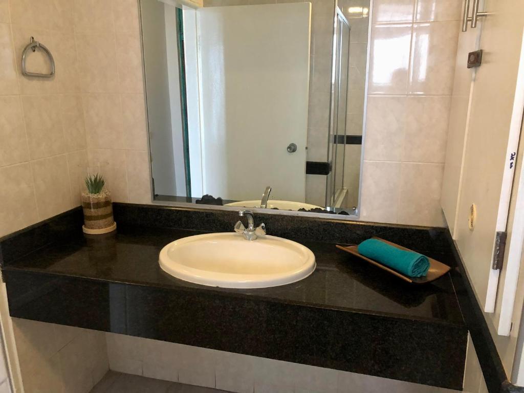 a bathroom counter with a sink and a mirror at T' Primage Suite on Ten South in Durban