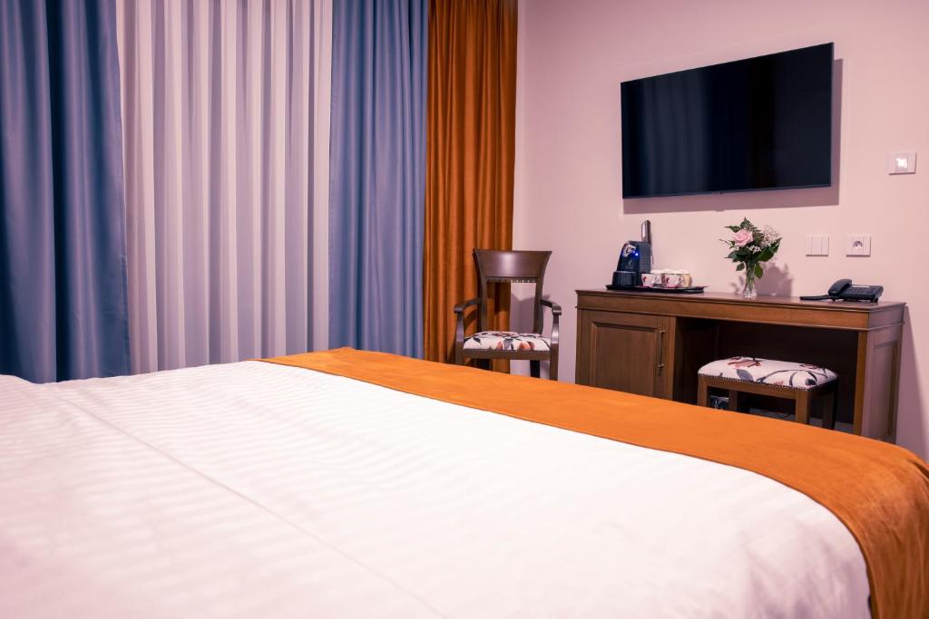 Postel nebo postele na pokoji v ubytování Hotel Aura Unirii