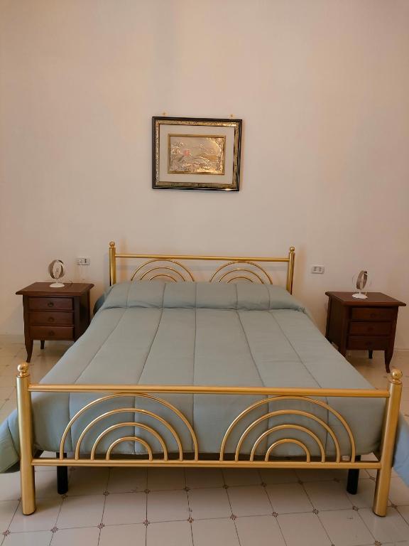 Łóżko lub łóżka w pokoju w obiekcie Cisterna's rooms