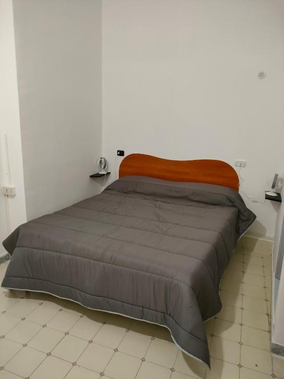 Łóżko lub łóżka w pokoju w obiekcie Cisterna's rooms