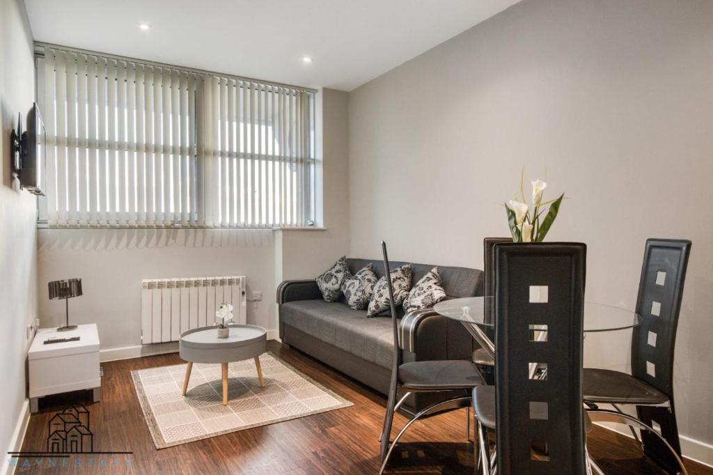 a living room with a couch and a table at Cosy 1-Bed by Heathrow Airport in London