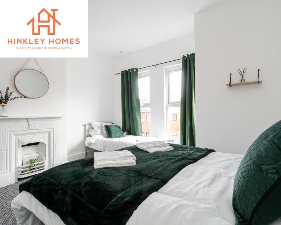 a bedroom with a bed with a black blanket at Comfy 4bed Home - Free Parking, Wifi - Long Stays Welcome By Hinkley Homes Short Lets & Serviced Accommodation in Litherland