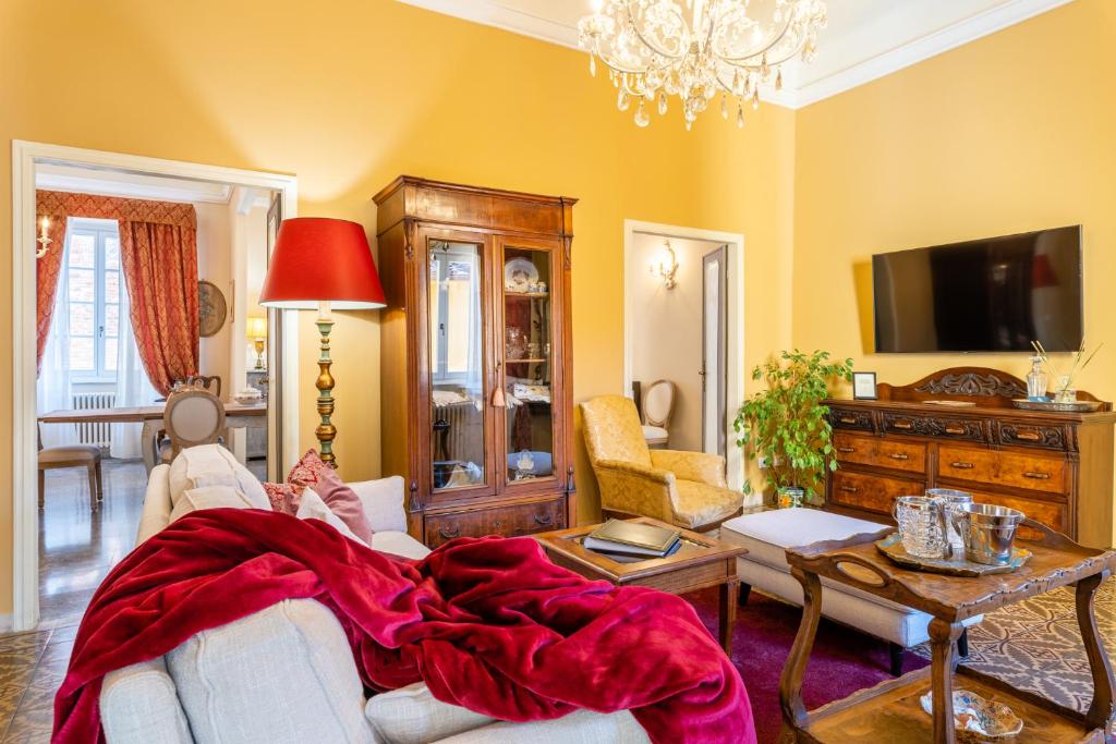 a woman laying on a couch in a living room at Villa De Maestri in Lucca