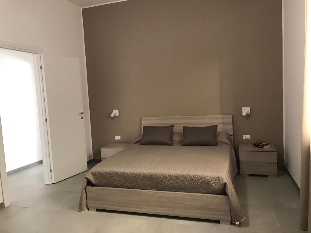 Łóżko lub łóżka w pokoju w obiekcie Scogliera apartments