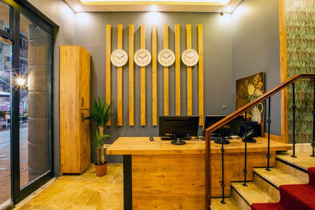 an office with clocks on the wall and a desk at Taksim Leon's Hotel in Istanbul