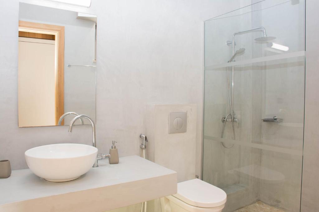 a bathroom with a sink and a toilet and a shower at Bali Diamond "by Checkin" Adults Only in Bali