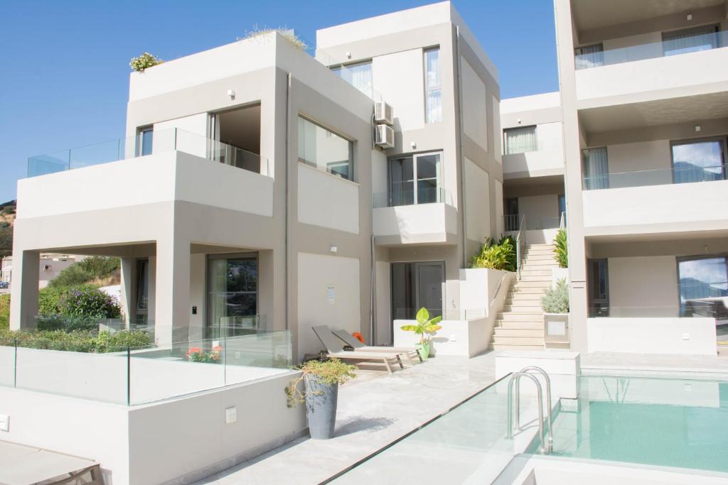 an apartment building with a balcony and a swimming pool at Bali Diamond "by Checkin" Adults Only in Bali