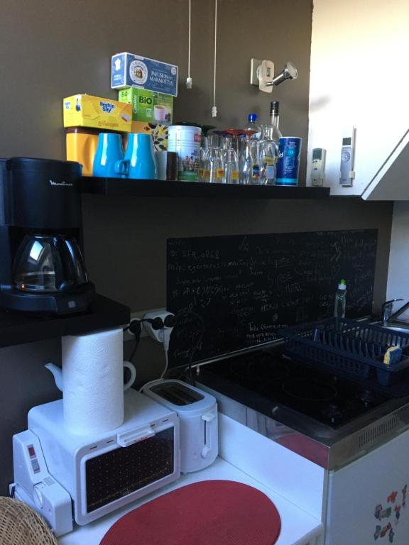 a kitchen with a counter top with a coffee maker at Studio centre-ville climatisé avec parking gratuit in Clermont-Ferrand