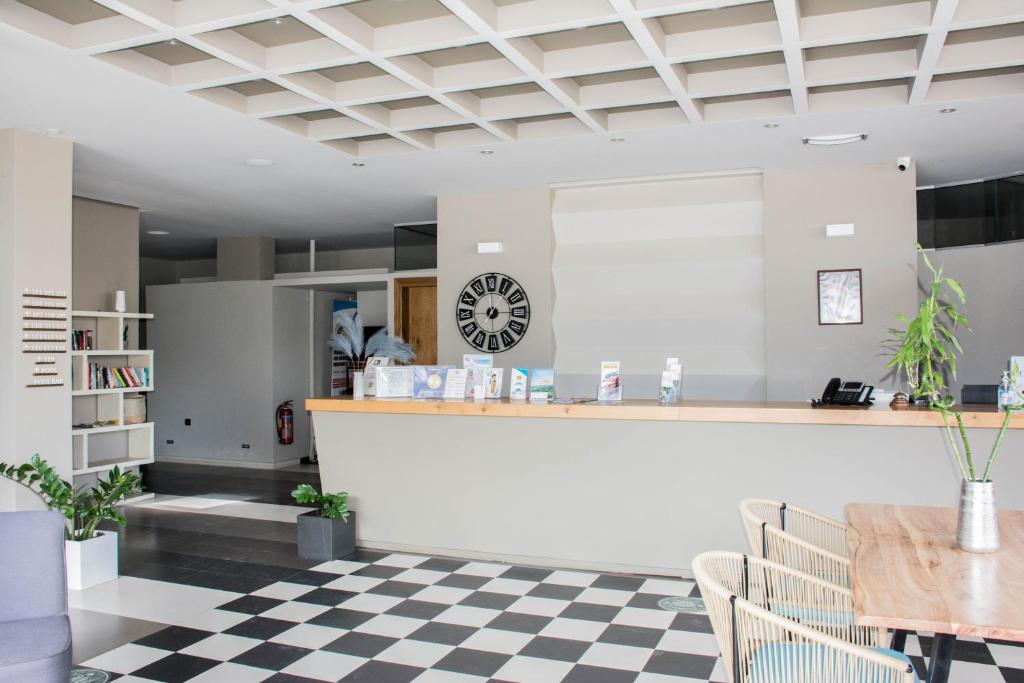 a restaurant with a counter and a checkered floor at Bali Diamond "by Checkin" Adults Only in Bali
