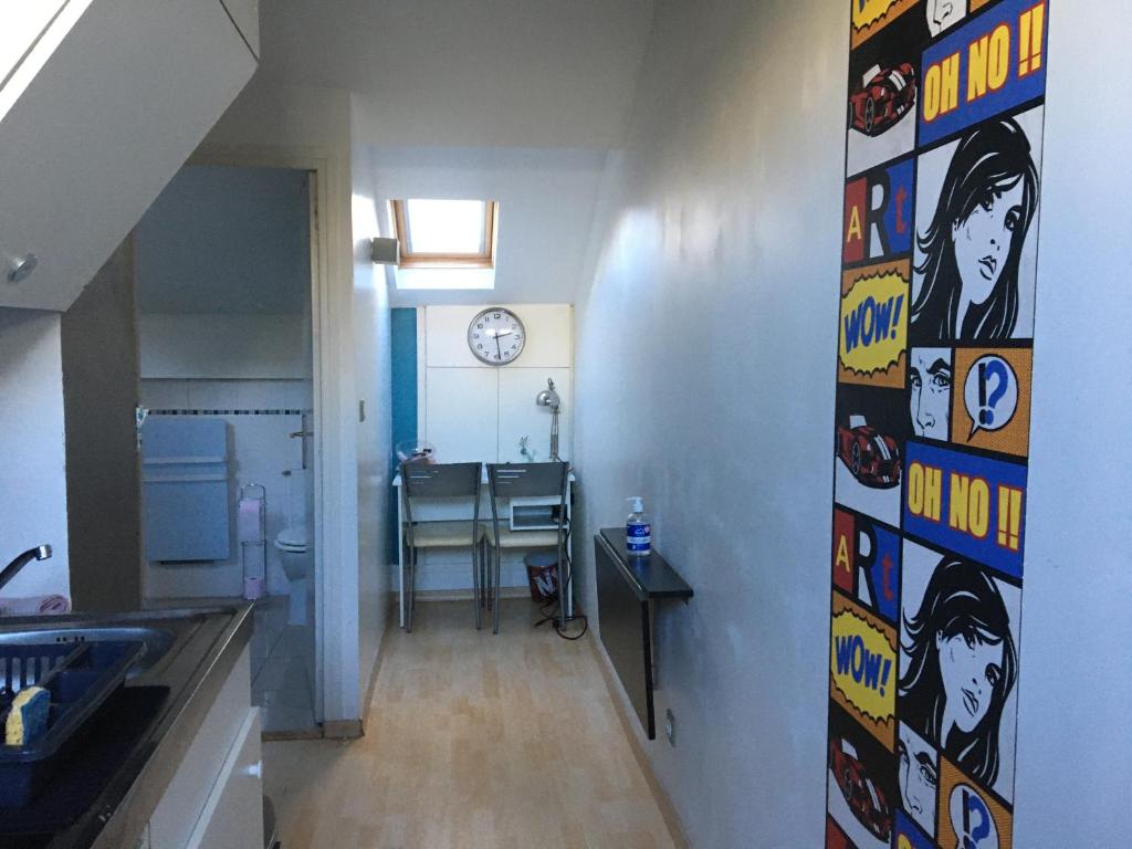 a kitchen with a bunch of stickers on the wall at Studio centre-ville climatisé avec parking gratuit in Clermont-Ferrand