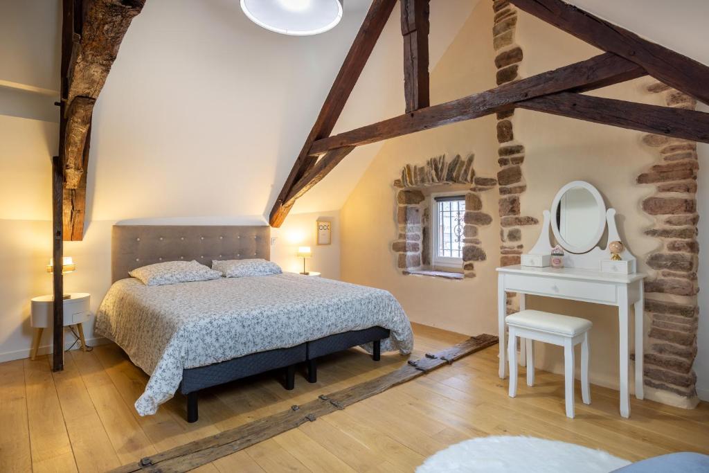 een slaapkamer met een bed, een tafel en een spiegel bij Le Chirac 5 T2 Centre Historique Rodez in Rodez