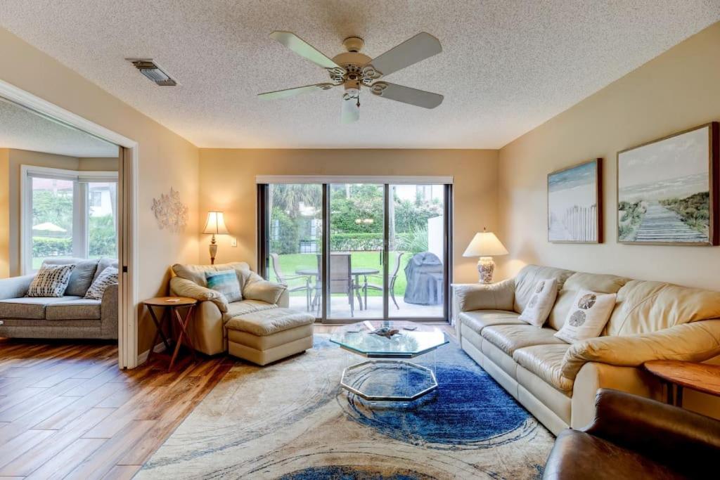a living room with a couch and a ceiling fan at Pool Golf and Welcome to ROCKVILLE Available in Daytona Beach