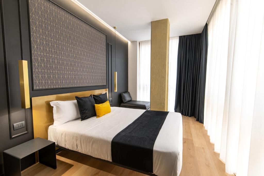 Łóżko lub łóżka w pokoju w obiekcie Plebiscito Boutique Rooms