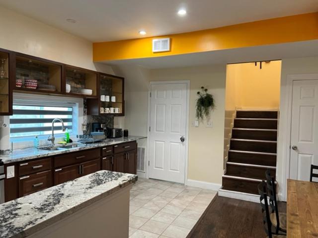 a kitchen with a sink and a staircase in it at Uber Close to Ohio City, Cleveland (Upper) in Cleveland