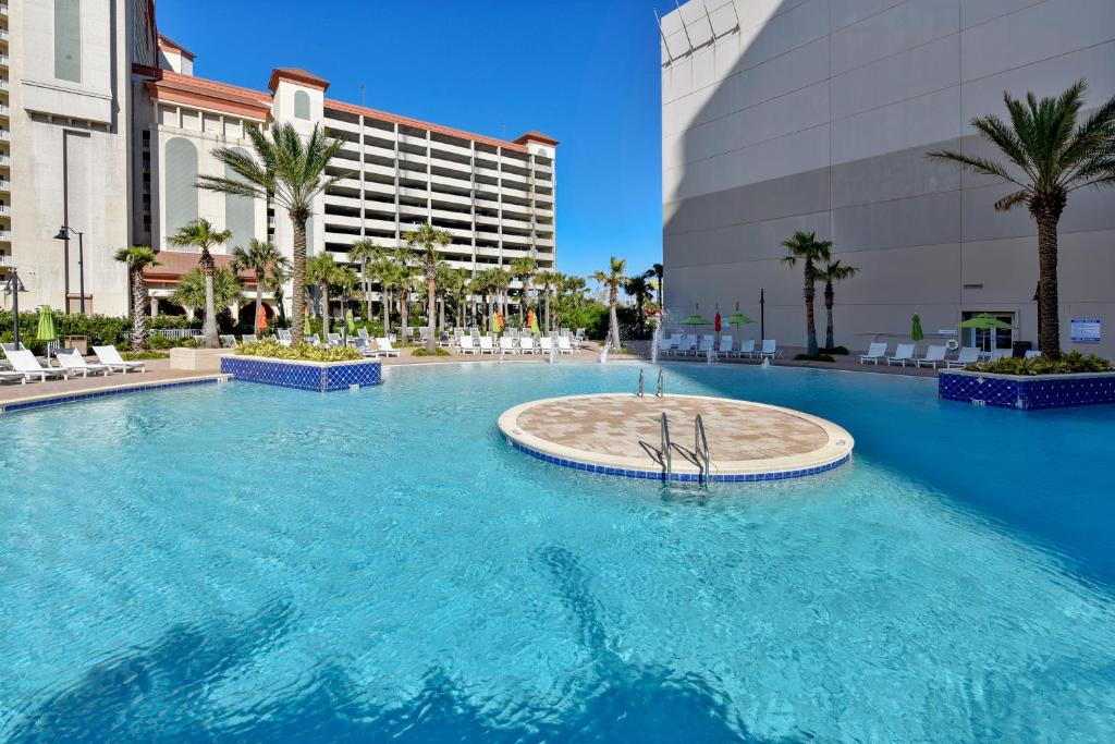 a large swimming pool in front of a building at Laketown Wharf #2023 by Book That Condo in Panama City Beach