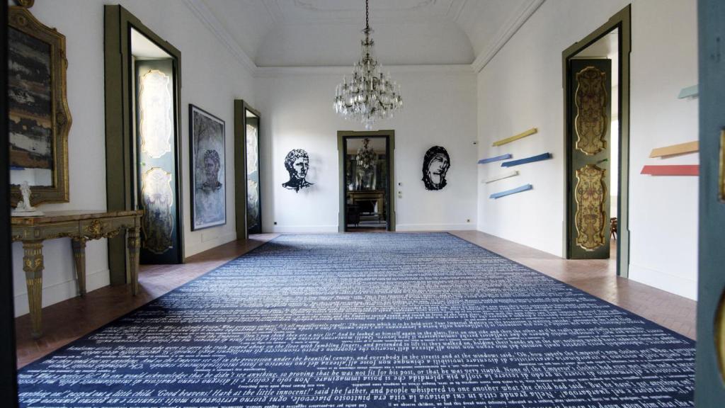 a hallway with a blue rug on the floor at Palazzo Luce in Lecce