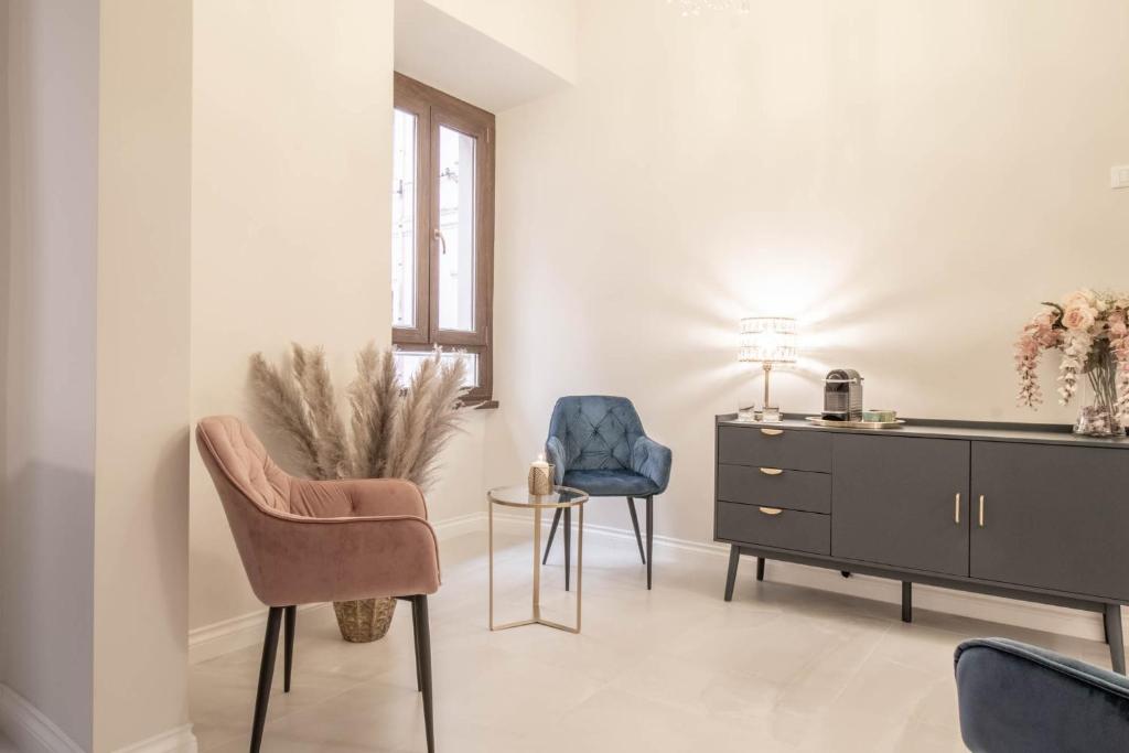 a living room with two chairs and a dresser at DANY GUEST HOUSE in Rome