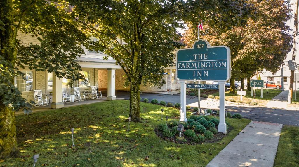 a sign for the immigration inn in front of a building at The Farmington Inn and Suites in Farmington