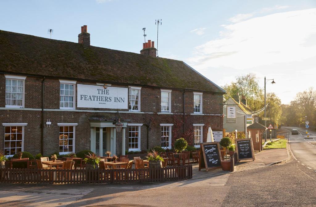 a brick building with a sign that reads the feathers inn at Feathers by Chef & Brewer Collection in Wadesmill