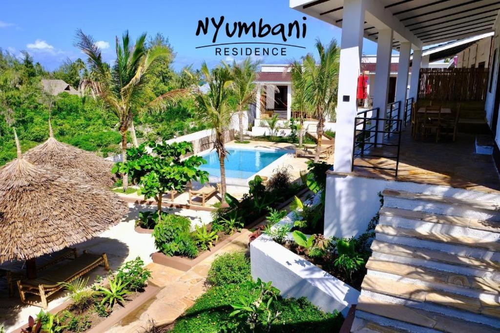 a view of a resort with a swimming pool at Nyumbani Residence Apartments in Jambiani