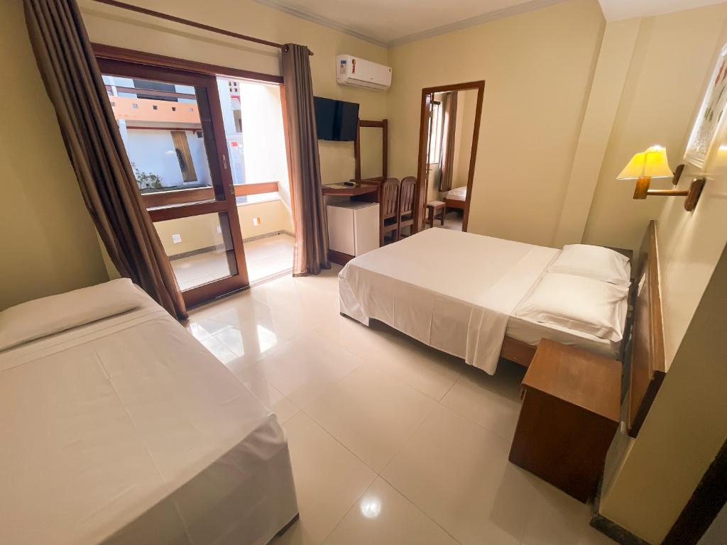Postel nebo postele na pokoji v ubytování Porto Cálem Praia Hotel