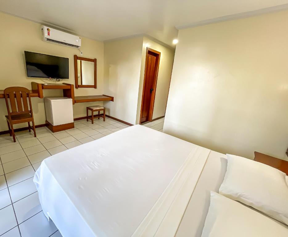 Postel nebo postele na pokoji v ubytování Porto Cálem Praia Hotel