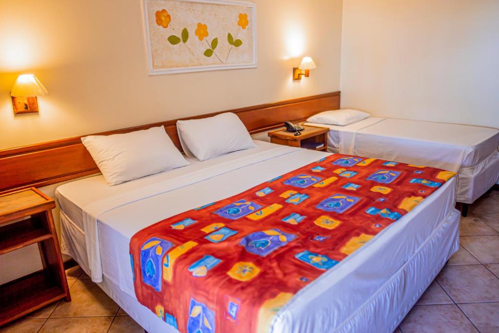 Postel nebo postele na pokoji v ubytování Porto Cálem Praia Hotel