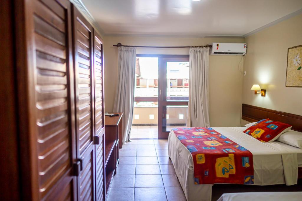 Postel nebo postele na pokoji v ubytování Porto Cálem Praia Hotel