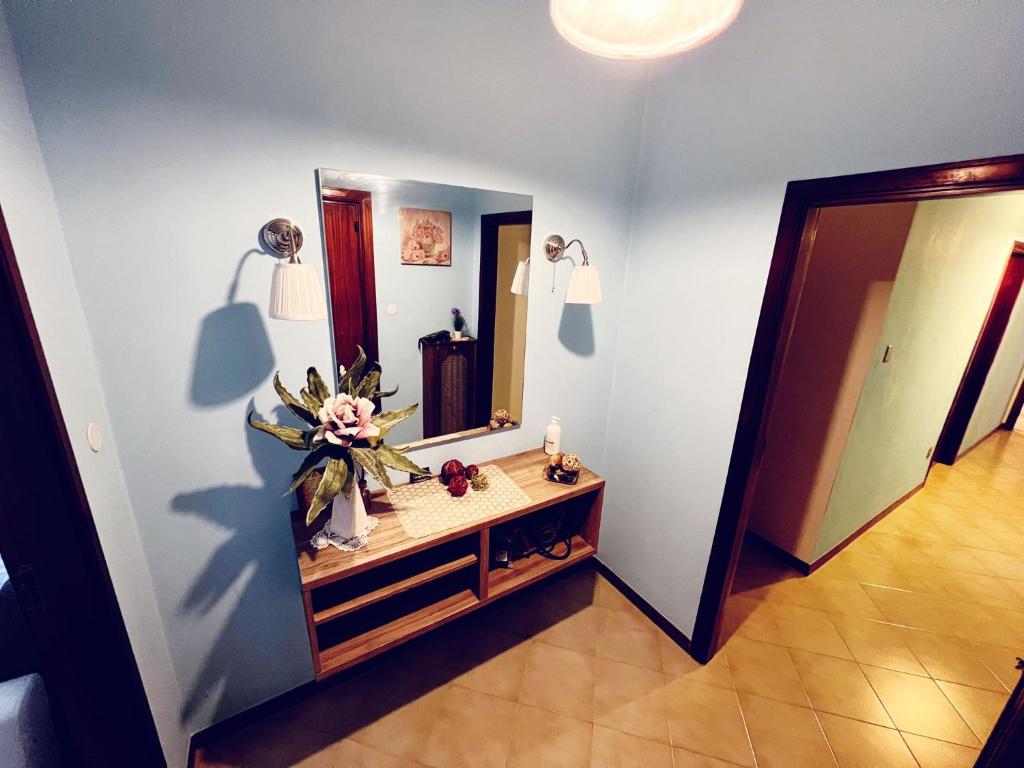 a bathroom with a vanity and a large mirror at Casa di Mattia in Pescara