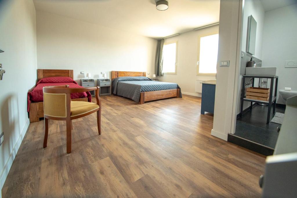 a room with a bed and a table and chairs at FORESTERIA LOMBARDA BED and BIKE CREMONA in Crotta dʼAdda