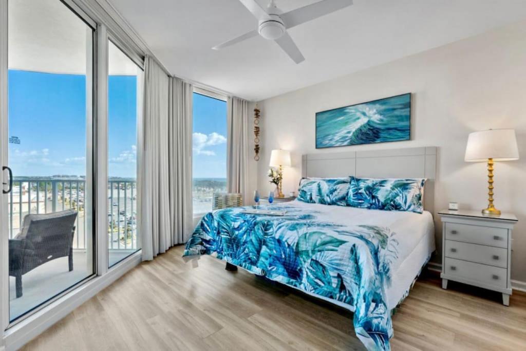 a bedroom with a bed and a large window at 5 Star Resort 6th fl 2BR 2 BATH King Suite Shuttle Pools, restaurants & more in Destin