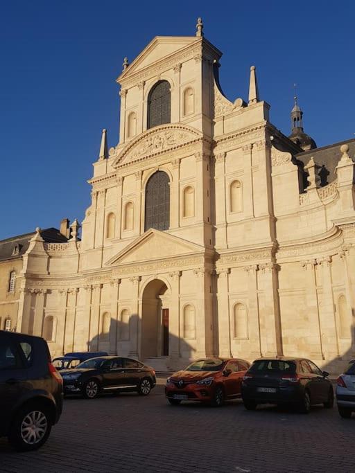 a large building with cars parked in front of it at LA MAISON POURRIE in Pont-à-Mousson