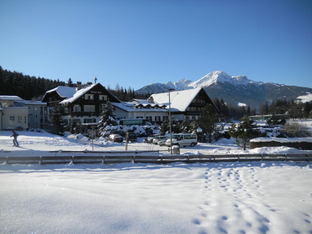 snow covered mountains and a ski lodge at Hotel Gruberhof Innsbruck-Igls- bed & breakfast in Innsbruck