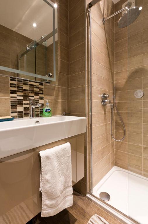 a bathroom with a sink and a shower at Leafy Suburban Bed and Breakfast in Northwood