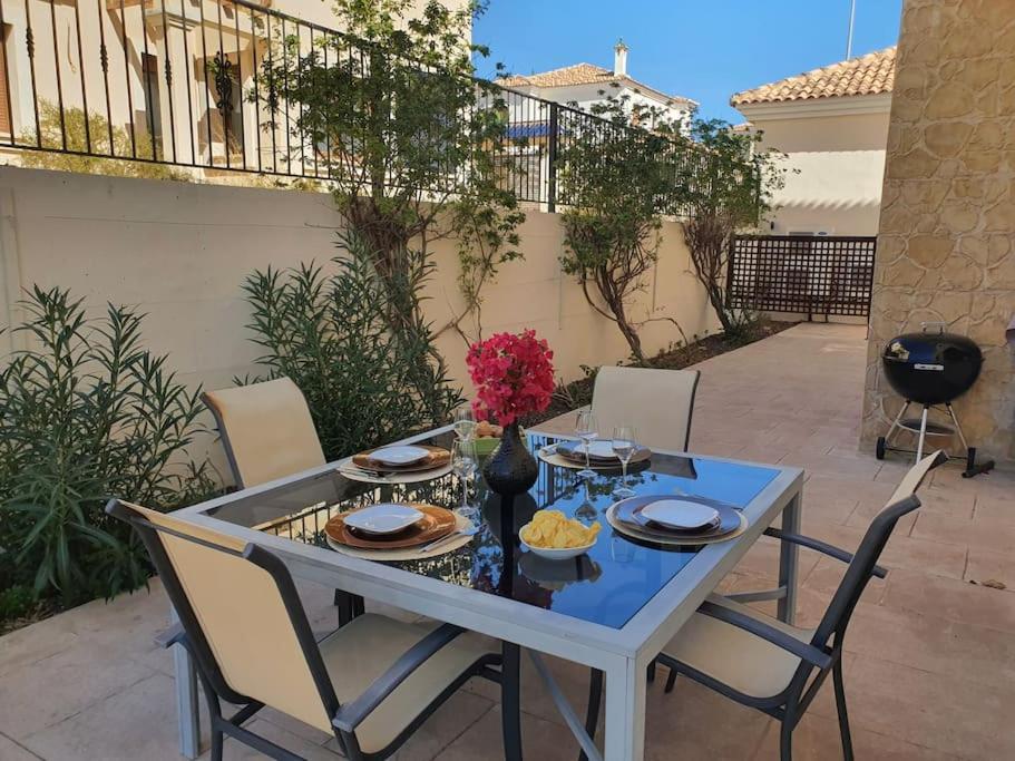 ein Tisch mit Stühlen und ein blauer Tisch sidx sidx sidx sidx in der Unterkunft Espectacular Villa PISCINA PRIVADA Altaona GOLF in Murcia
