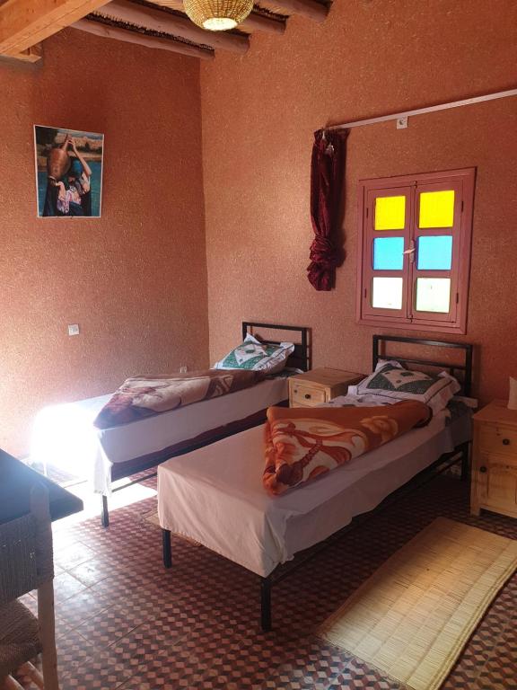 Un ou plusieurs lits dans un hébergement de l'établissement Camping Hôtel la Vallée d'Ammelne