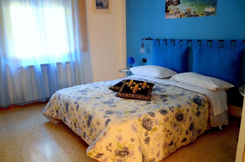 Łóżko lub łóżka w pokoju w obiekcie L'Acchiappasogni