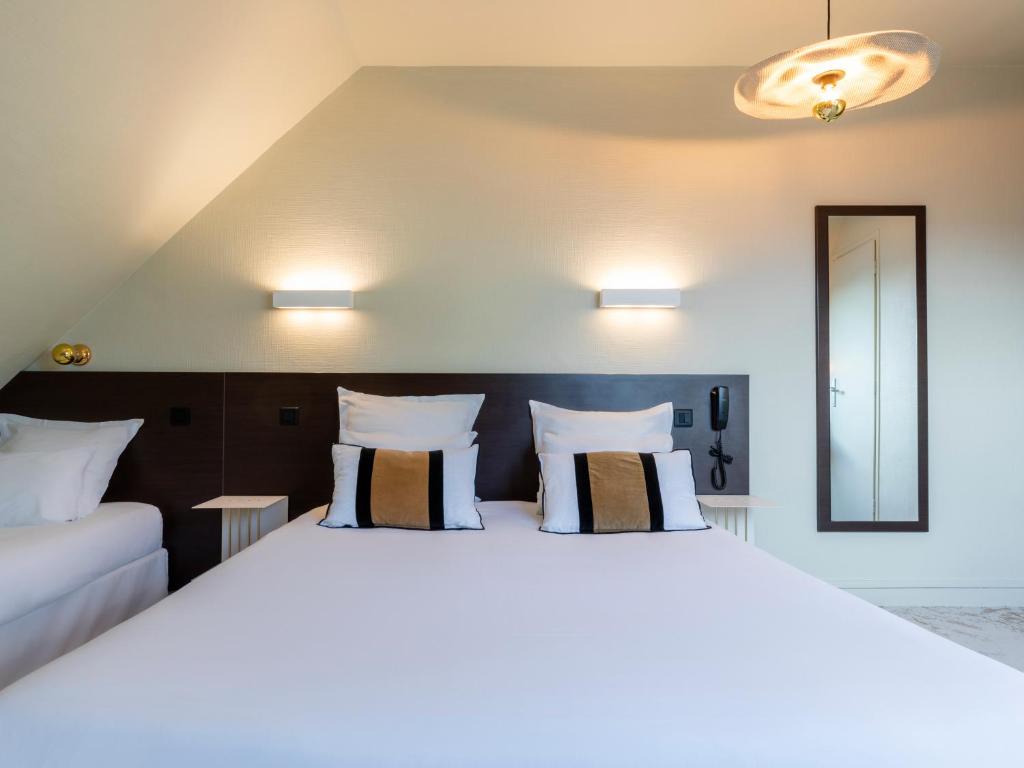 Postel nebo postele na pokoji v ubytování MOKA Hôtel