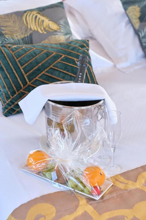 a table with a basket of food and wine glasses at Hotel Ciutat Jardi in Palma de Mallorca