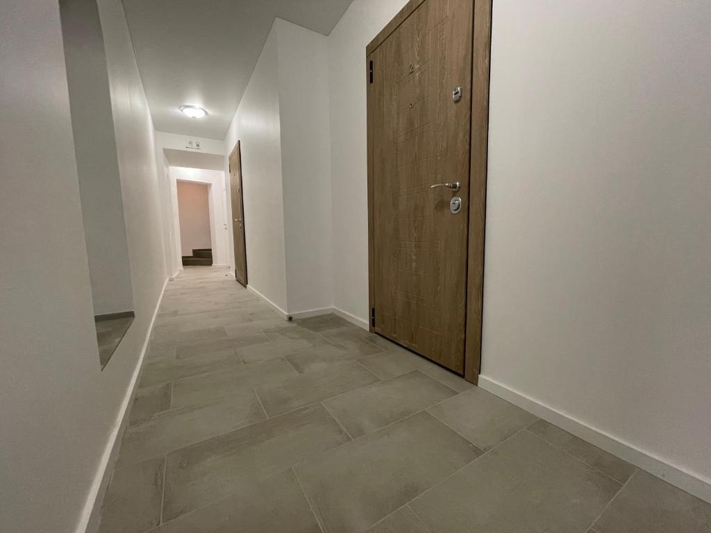 a hallway with a door and a tile floor at Modern guest house in city center I Room 3 in Vilnius